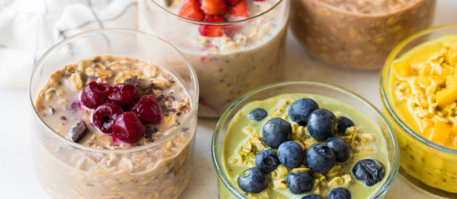 five different variants of protein overnight oats in glass bowls